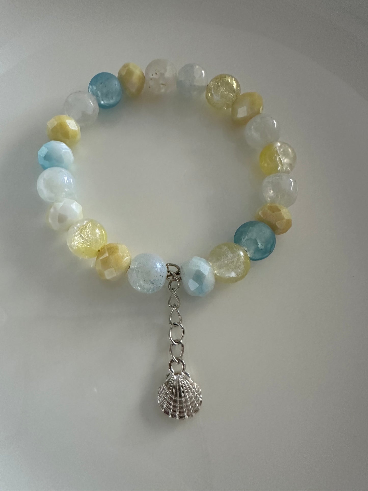 Blue, yellow and white bracelet with charms.