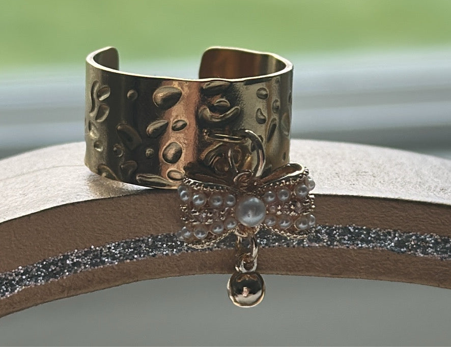 Adjustable ring with a bow.